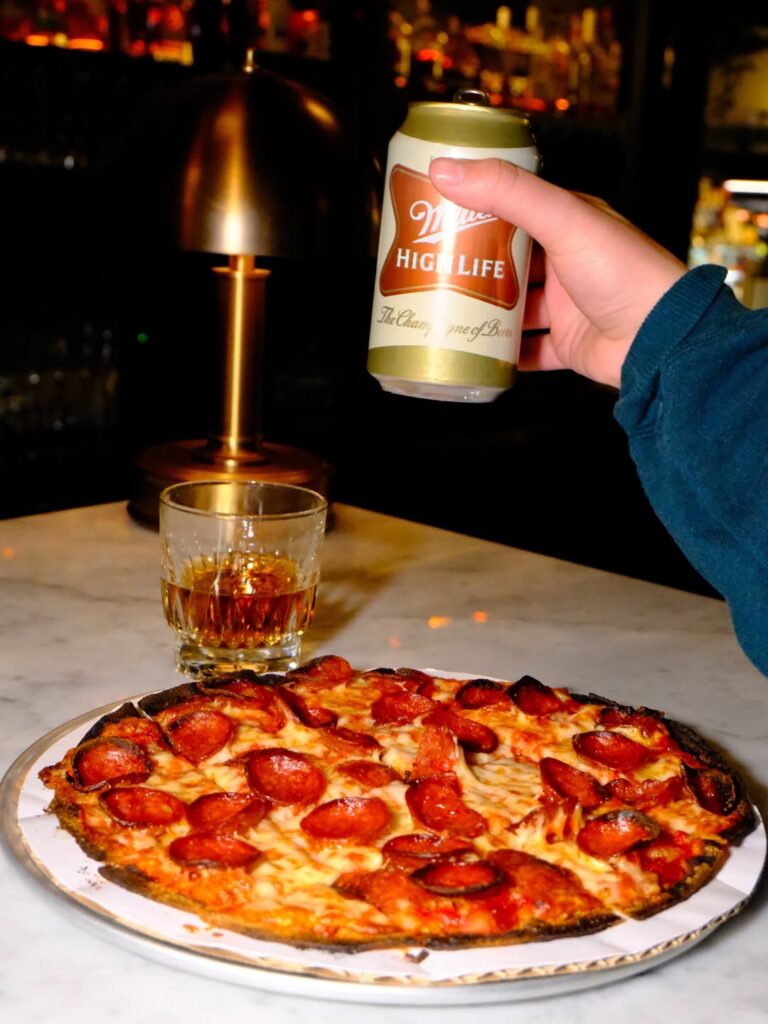 Celebrating with pizza and a high life at Wolf and Company