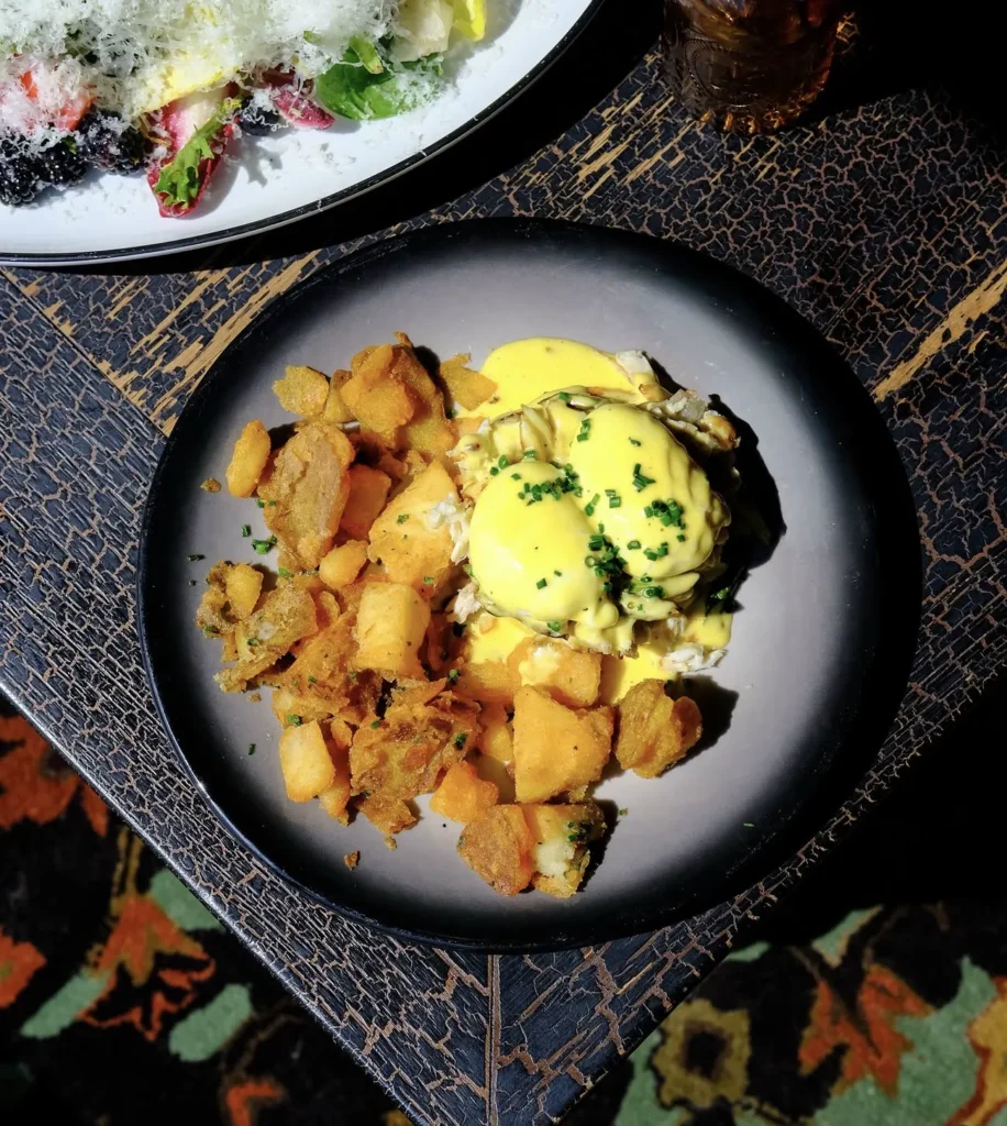 Crab and asparagus benedict with hollandaise and breakfast potatoes at Wolf & Co.