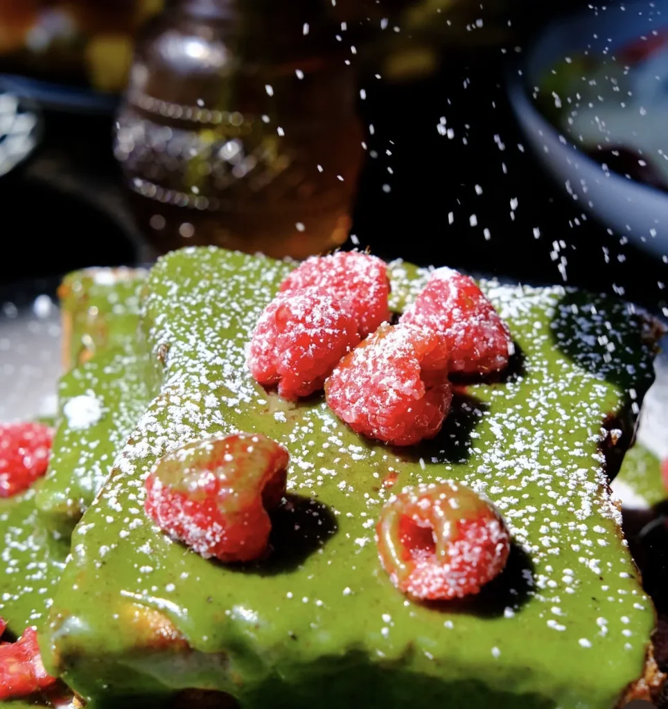 Pistachio French toast with raspberries and whipped cream at Wolf & Co.